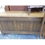 A 20th C. OAK COFFER, THE THREE PANELLED FRONT CARVED WITH LINEN FOLD. W 105 x D 46 x H 51cms.