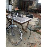 TEAK GARDEN TABLE AND TWO WROUGHT IRON CHAIRS