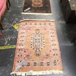TWO ORIENTAL RUGS OF BOKHARA DESIGN. 122 x 81cms AND 132 x 76cms