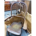 AN OAK AND ELM WINDSOR CHAIR WITH ROUND ARCHED NINE STICK BACK AND TURNED LEGS