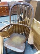 AN OAK AND ELM WINDSOR CHAIR WITH ROUND ARCHED NINE STICK BACK AND TURNED LEGS