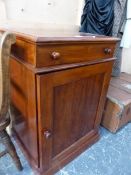 A MAHOGANY WASHSTAND CUPBOARD, THE LID OPENING ONTO A WASH BOWL RECEIVER ABOVE THE CUPBOARD AND