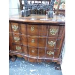 A DUTCH EAST INDIAN HARDWOOD CHEST OF THREE WAVY FRONTED DRAWERS ON BALL AND CLAW FEET. W 77 x D