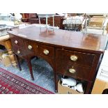 A 19th C. MAHOGANY BOW FRONT SIDE BOARD, THE CENTRAL DRAWER FLANKED BY TWO OTHERS AND A CELLARETTE