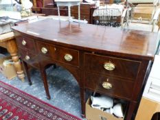 A 19th C. MAHOGANY BOW FRONT SIDE BOARD, THE CENTRAL DRAWER FLANKED BY TWO OTHERS AND A CELLARETTE