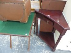 A MAHOGANY TWO TIER CORNER TABLE, A BROWN LEATHERETTE BOX STOOL TOGETHER WITH A FOLDING GAMES TABLE