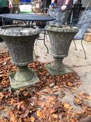 A PAIR OF CAST STONE PLANTERS. H. 67cms