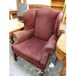 A 20th C. WING ARMCHAIR UPHOLSTERED IN PURPLE ON CHANNELED SQUARE SECTION MAHOGANY FRONT LEGS