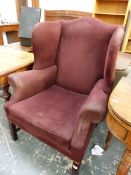 A 20th C. WING ARMCHAIR UPHOLSTERED IN PURPLE ON CHANNELED SQUARE SECTION MAHOGANY FRONT LEGS