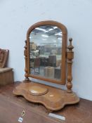 A PINE DRESSING TABLE MIRROR, THE ROUNDED TOPPED RECTANGULAR PLATE BETWEEN TURNED COLUMNS AND WAVY