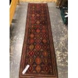 A BELOUCH TRIBAL RUNNER. 282 x 81cms. TOGETHER WITH A MACHINE MADE RUG (2)