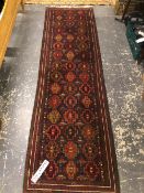 A BELOUCH TRIBAL RUNNER. 282 x 81cms. TOGETHER WITH A MACHINE MADE RUG (2)