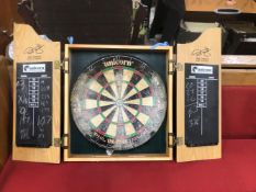 A WALL MOUNTED DART BOARD CASE.