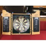 A WALL MOUNTED DART BOARD CASE.