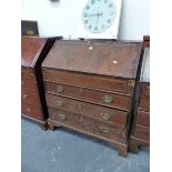 A GEORGE III MAHOGANY BUREAU, THE OAK BANDED FALL ENCLOSING A WELL ABOVE THREE GRADED LONG DRAWERS