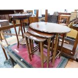 A 20th C. NEST OF THREE OAK OVAL TABLES, A FLORAL CARVED TWO TIER OCTAGONAL TABLE AND A TREFOIL