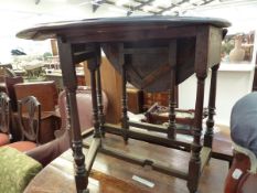 AN OAK OVAL DROP FLAP TABLE ON TURNED LEGS WITH INVERTED GOBLET SHAPED FEET. W 82 x D 69 x H 69cms