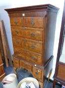 A 20th C. WALNUT CHEST ON STAND, THE CONFIGURATION OF EIGHT CROSS BANDED DRAWERS ABOVE CABRIOLE LEGS