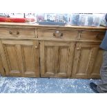 A VICTORIAN PINE DRESSER WITH THREE DRAWERS OVER TWO DOORS FLANKING THE CENTRAL PANEL. W 206 x D 60