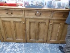 A VICTORIAN PINE DRESSER WITH THREE DRAWERS OVER TWO DOORS FLANKING THE CENTRAL PANEL. W 206 x D 60