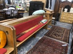 A PAIR OF OAK PEWS, THE NARROW SIDES PIERCED WITH CIRCULAR HOLES, EACH. W 243 x D 46 x H 92cms.