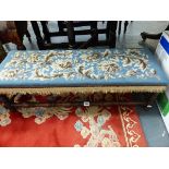 AN OAK DOUBLE FOOTSTOOL WITH BLUE GROUND FLORAL NEEDLE WORK SEAT