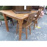 A PINE TABLE ON TURNED AND TAPERING CYLINDRICAL LEGS. W 151 x D 80 x H 74cms. TOGETHER WITH TWO