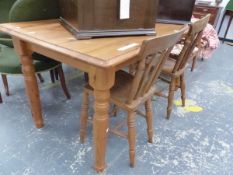 A PINE TABLE ON TURNED AND TAPERING CYLINDRICAL LEGS. W 151 x D 80 x H 74cms. TOGETHER WITH TWO