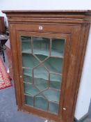 A GEORGE III ASTRAGAL GLAZED OAK CORNER CUPBOARD