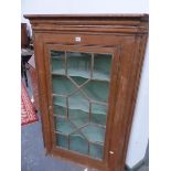 A GEORGE III ASTRAGAL GLAZED OAK CORNER CUPBOARD