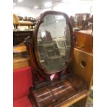 A VICTORIAN MAHOGANY DRESSING TABLE MIRROR, THE QUATREFOIL PLATE BETWEEN FOLIATE ARMS RESTING ON A