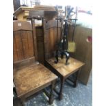 A PAIR OF ARTS AND CRAFTS OAK CHAIRS WITH PEDIMENT TOPPED PLANK BACKS AND SOLID SEATS
