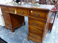 A 20th C. PEDESTAL DESK, THE LEATHER INSET TOP ABOVE A KNEEHOLE DRAWER FLANKED BY BANKS OF FOUR ON