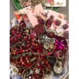 A COLLECTION OF COSTUME JEWELLERY PREDOMINATELY PINK AND RED TONED.