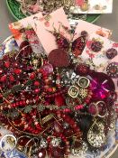 A COLLECTION OF COSTUME JEWELLERY PREDOMINATELY PINK AND RED TONED.