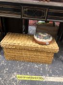 A WICKER BOX WITH COVER AND A SMALL EMBROIDERED FOOT STOOL.