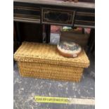 A WICKER BOX WITH COVER AND A SMALL EMBROIDERED FOOT STOOL.