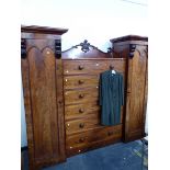 A VICTORIAN MAHOGANY COMPACTUM WARDROBE WITH TWO CUPBOARDS FLANKING SIX DRAWERS. W 231 x D 58 x H