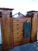 A VICTORIAN MAHOGANY COMPACTUM WARDROBE WITH TWO CUPBOARDS FLANKING SIX DRAWERS. W 231 x D 58 x H