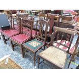 A SET OF SIX MAHOGANY DINING CHAIRS WITH PIERCED LADDER BACKS AND RED DROP IN SEATS TOGETHER WITH