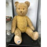 A LARGE VINTAGE JOINTED TEDDY BEAR.