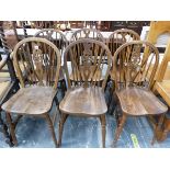 A SET OF SIX WHEEL BACK CHAIRS TOGETHER WITH TWO ELBOW CHAIRS WITH CANED BACKS AND RUSH SEATS