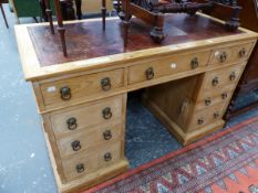 A LATE VICTORIAN PINE PEDESTAL DESK WITH LEATHER INSET TOP, THE KNEEHOLE DRAWER FLANKED BY BANKS OF