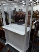 A PAIR OF WHITE PAINTED DISPLAY SHELVES, DOUBLE SIDED AND WITH CENTRAL GLASS PANELS. W 100 x D 30