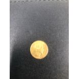A GOLD 1860 FRENCH FIVE FRANC COIN.