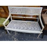 A WHITE PAINTED AND CANED TWO SEAT BENCH