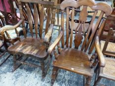 TWO SADDLE SEATED ROCKING CHAIRS WITH WAVY TOP RAILS AND WITH ARMS