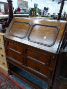 AN EARLY 20th C. OAK BUREAU, THE TWO PANELLED FALL OVER TWO LONG DRAWERS, THE BALUSTER LEGS JOINED