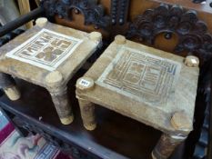 A PAIR OF ETHNIC STOOLS WITH CUT FUR SEATS INSCRIBED MUNA AND LUUL