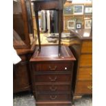 AN ANTIQUE MAHOGANY TRIANGULAR TOPPED WINE TABLE ON THREE CYLINDRICAL LEGS TAPERING TO PAD FEET.